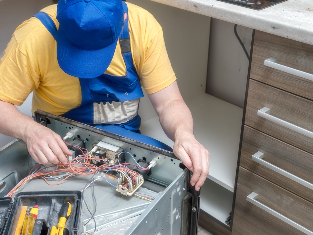 Technician repairing appliance